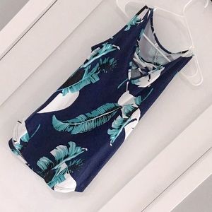 Tank with criss cross cutout on front